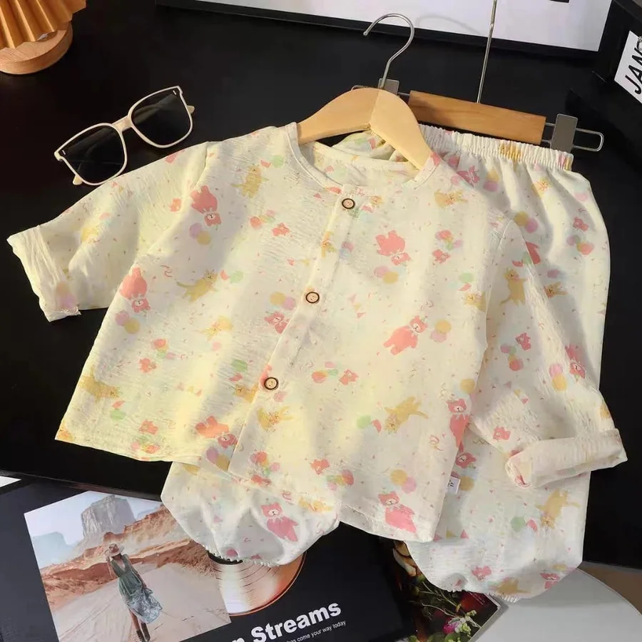 Boy wearing a cream printed Kito Mito outfit